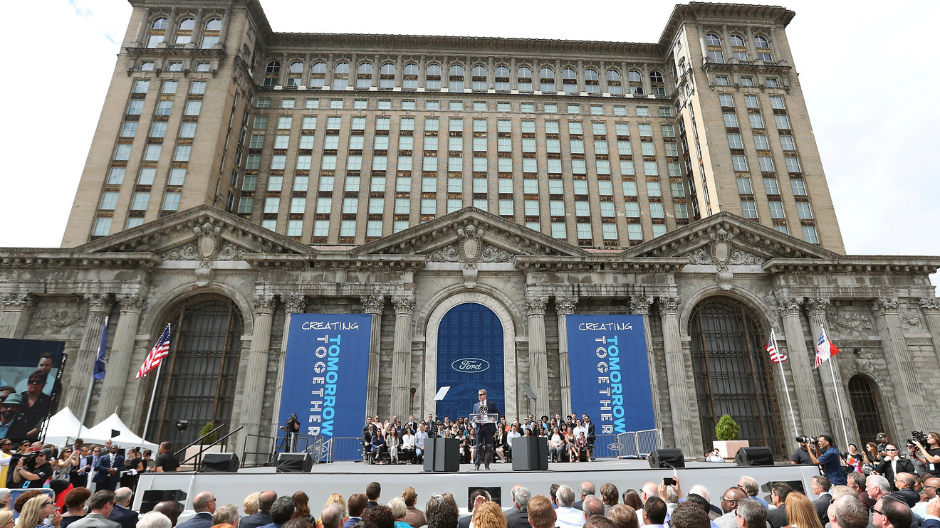 In this June 19, 2018, file photo, Ford Motor Co., Executive Chairman Bill Ford addresses attendees outside the Michigan Central Train Depot, in Detroit. Ford Motor Co. is expanding its footprint in Detroit's Corktown neighborhood by adding onto plans that began with its purchase and renovation of the massive and once-derelict station. The Dearborn, Michigan-based automaker also plans to turn a vacant book warehouse into the industrial center for its 30-acre Michigan Central mobility innovation district. Details were released Tuesday, Nov. 17, 2020, and are part of Ford's $740 million project to create an innovation hub to help shape the way people and goods will move around in the future.