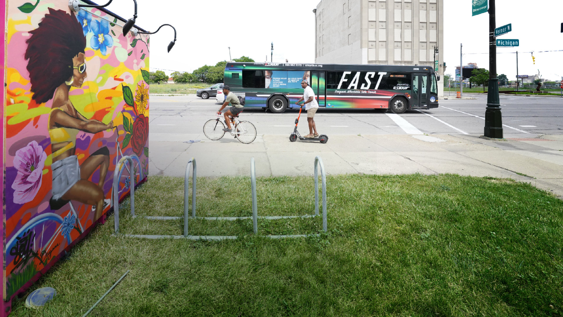 people on bikes and scooters on Detroit street