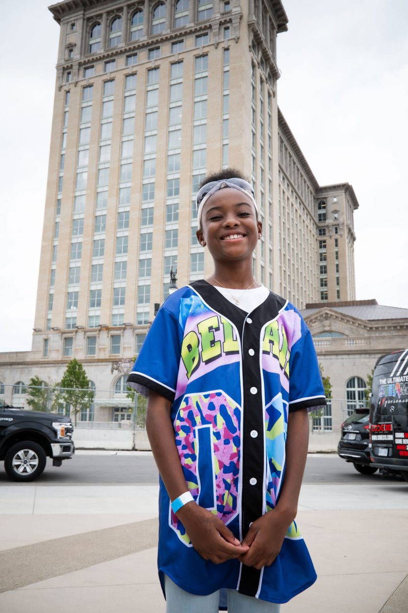 A child stands in front of The Station smiling big at the Drone Day event.